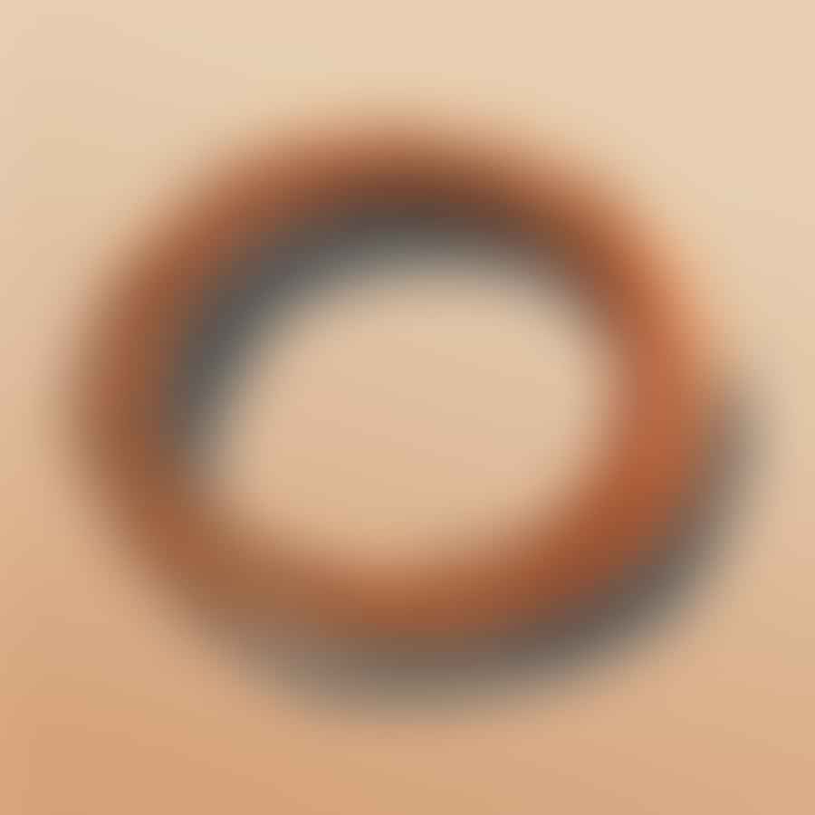 A coil of clay arranged in a circle to form a base.